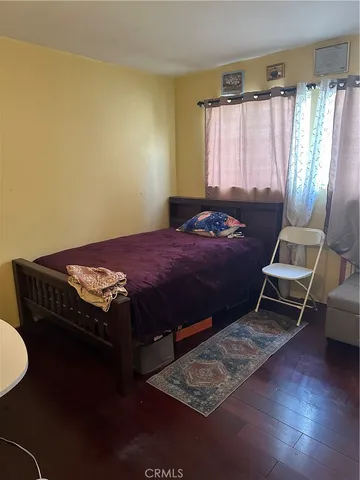 a bedroom with a bed dresser and a window