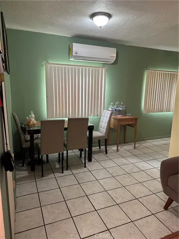 a living room with chairs and a window