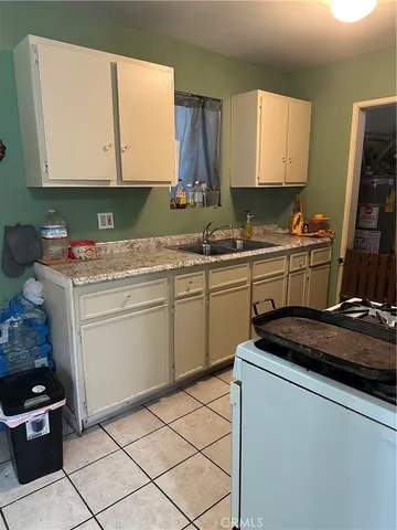 a kitchen with a sink stove and cabinets