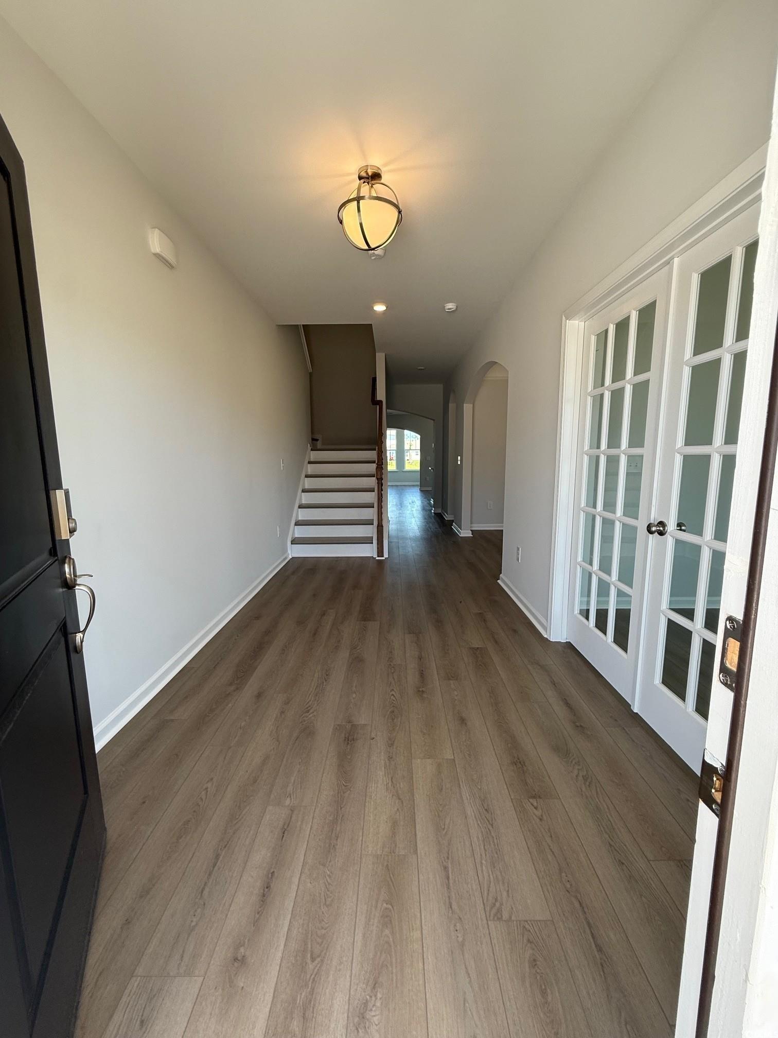 4008 Bucolic Loop Myrtle Beach, SC 29588 - Photo 2 of 39 Hallway featuring arched walkways, wood finished f