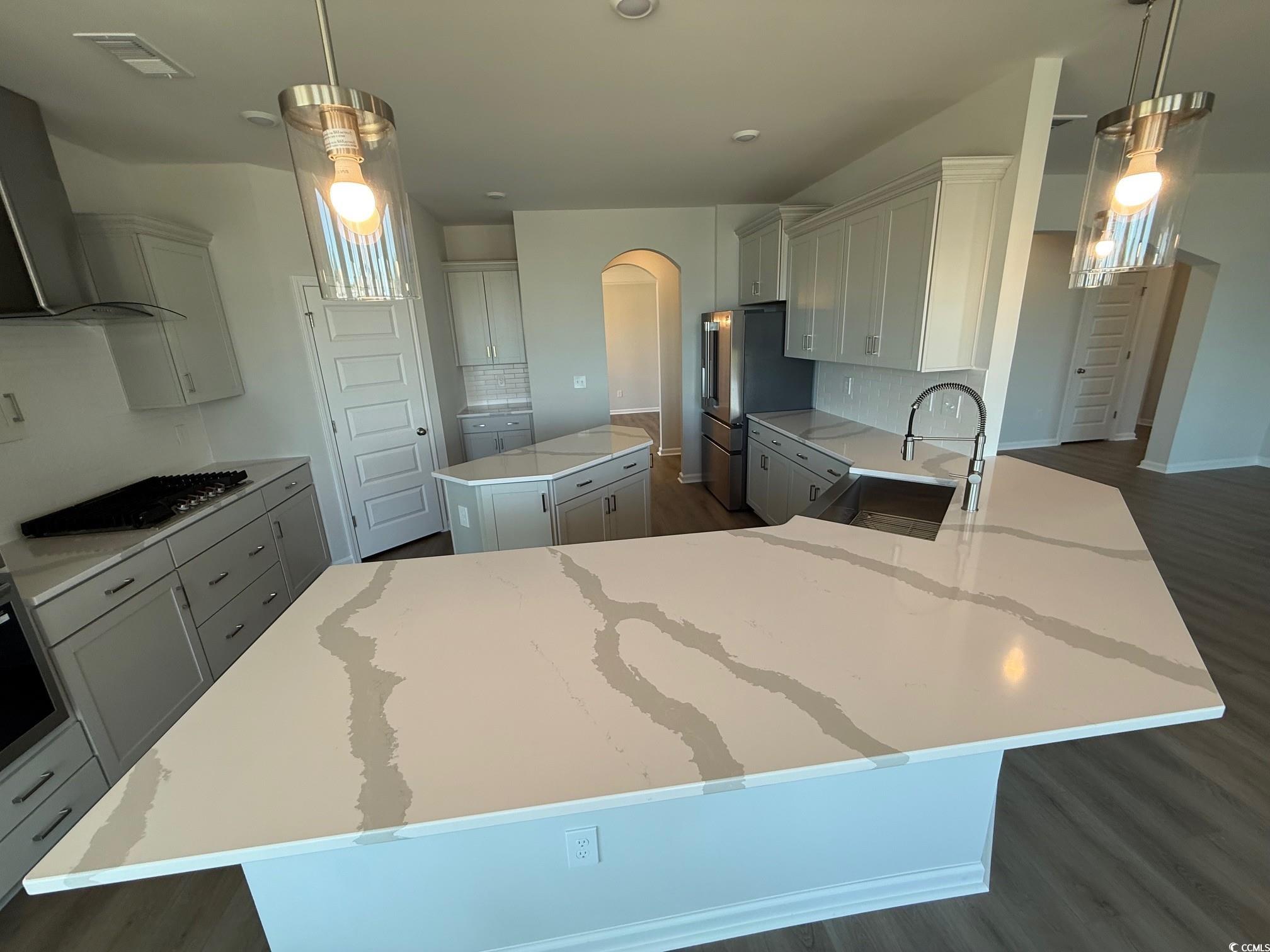 4008 Bucolic Loop Myrtle Beach, SC 29588 - Photo 4 of 39 Kitchen with a sink, a kitchen island, arched walk