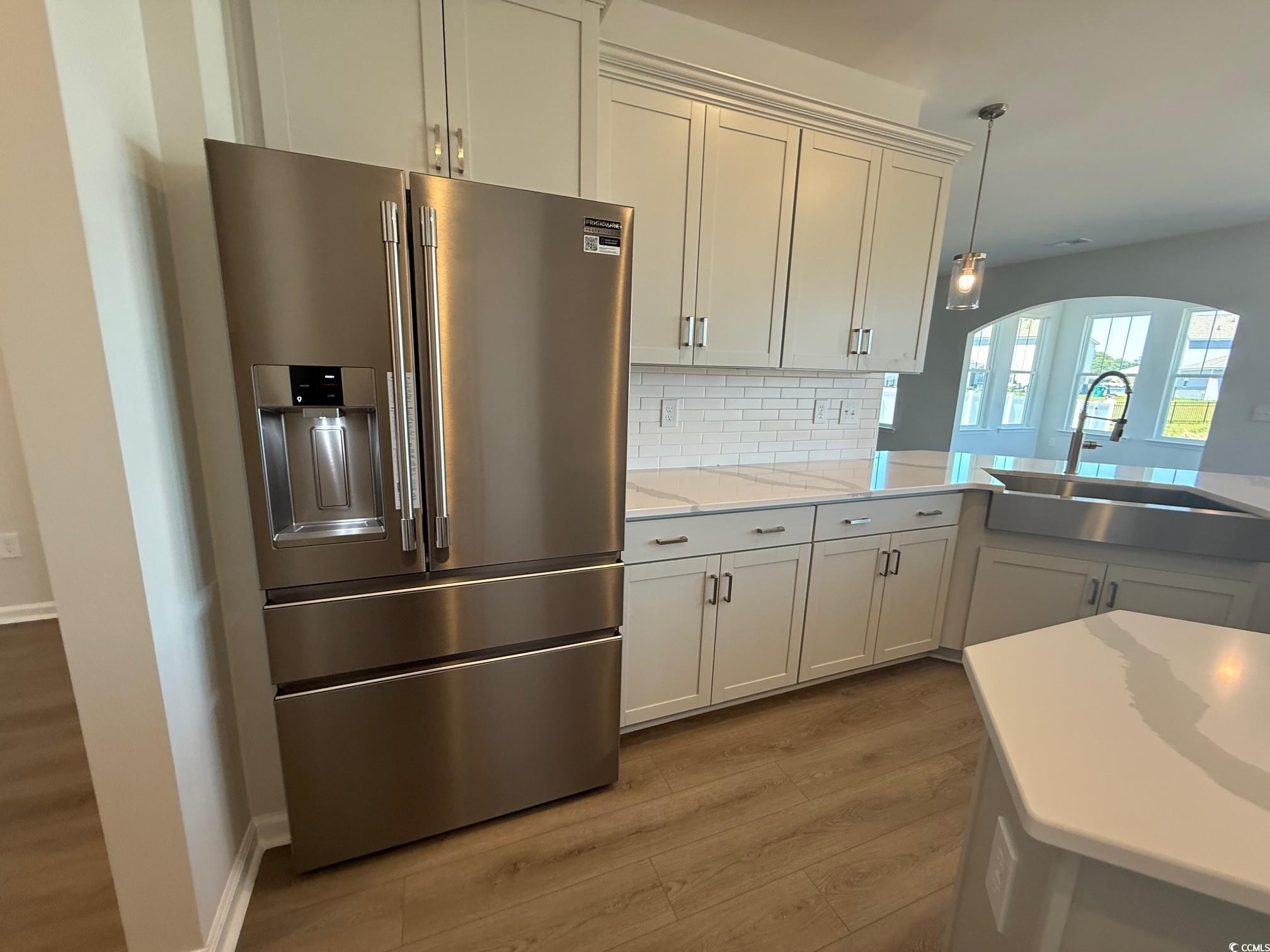 4008 Bucolic Loop Myrtle Beach, SC 29588 - Photo 6 of 39 Kitchen with high end fridge, a sink, wood finishe