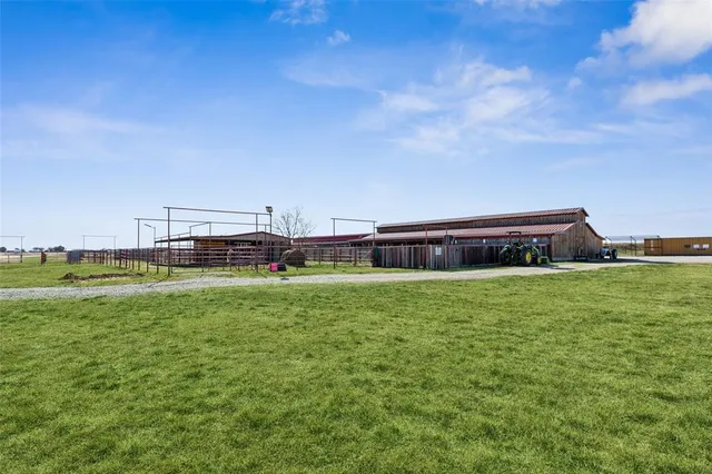 a view of a field with wooden fence
