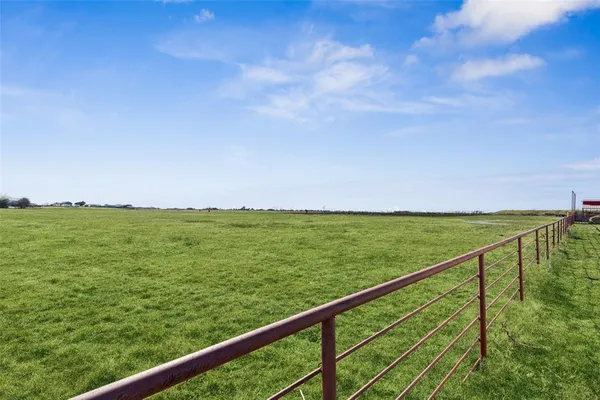 a view of a big house with a big yard