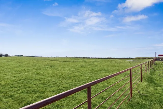 a view of a big house with a big yard