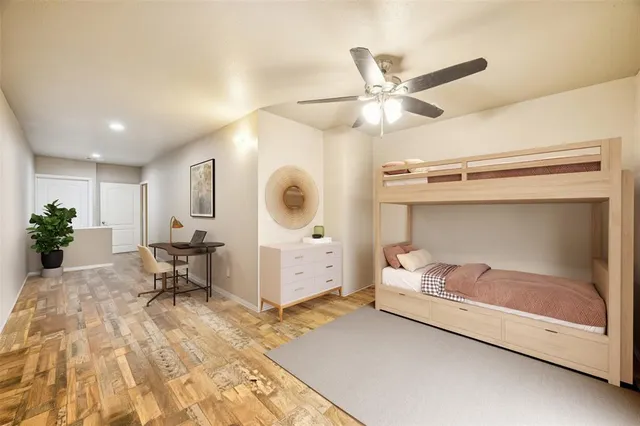 a bedroom with a large bed couch and a window