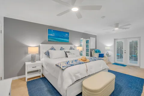 a bedroom with a bed and a lamp on dresser