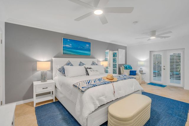 a bedroom with a bed and a lamp on dresser