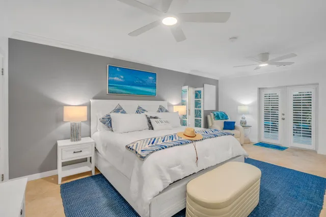 a bedroom with a bed and a lamp on dresser