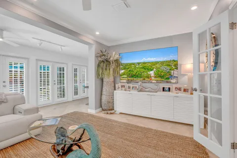 a bedroom with furniture and a large window
