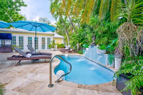 a view of a table and chairs under an umbrella in the patio