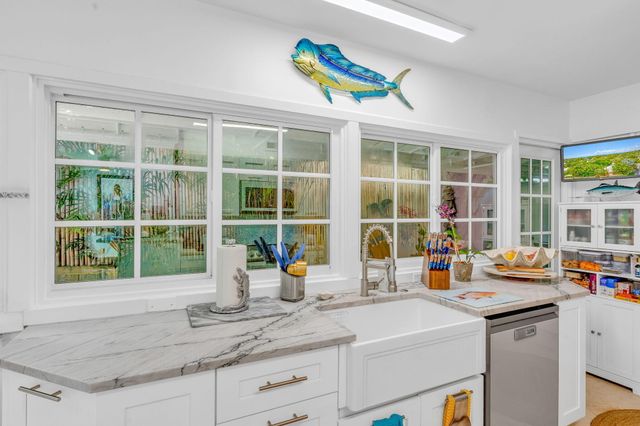 a kitchen with a sink and a large window