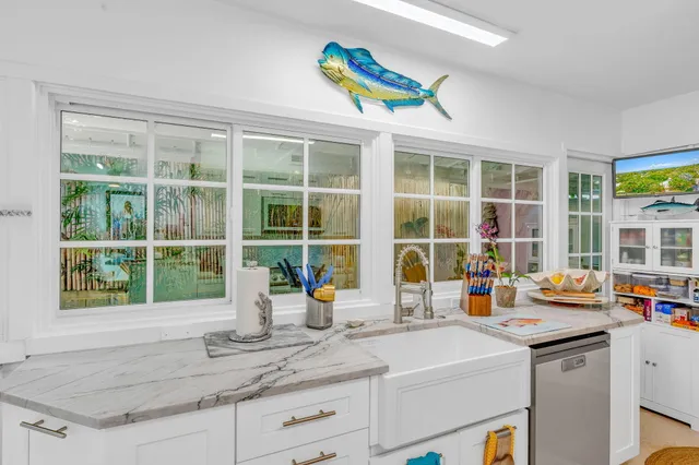 a kitchen with a sink and a large window