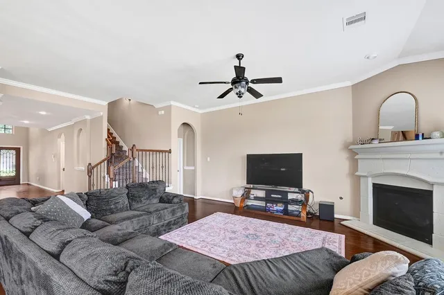 a living room with furniture a flat screen tv and a fireplace