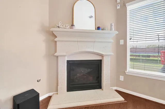 a living room with a fireplace and a window