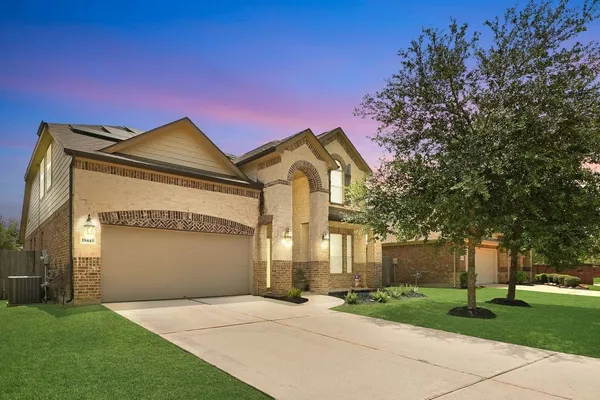 a front view of a house with a yard and garage