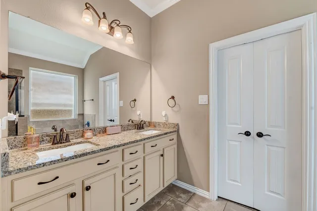 a spacious bathroom with a granite countertop sink a mirror and a
