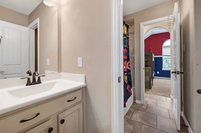 a en suite bathroom with a sink and a mirror