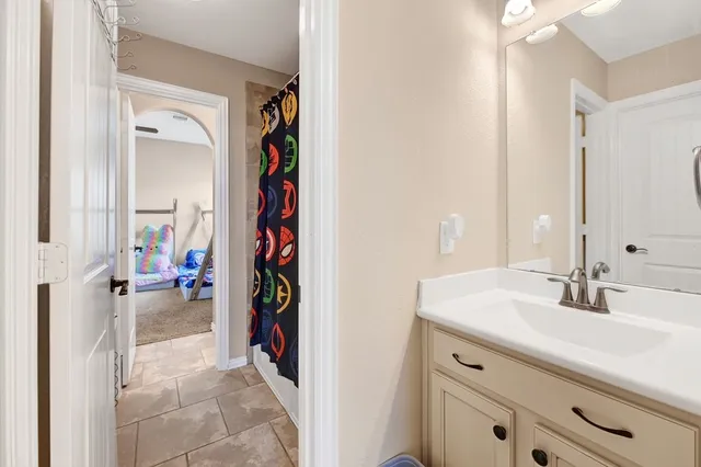 a en suite bathroom with a sink and a mirror