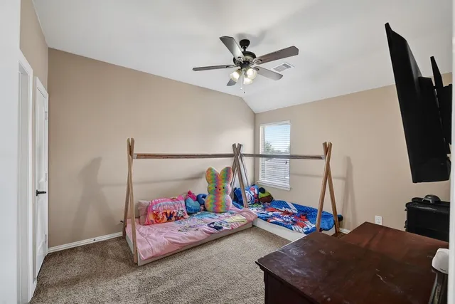 a bedroom with furniture and a flat screen tv