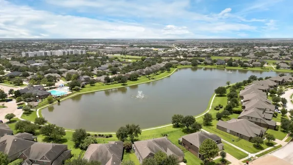 an aerial view of a house with a garden and lake view