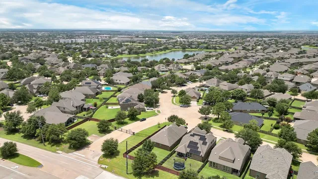 an aerial view of a house with garden space and street view