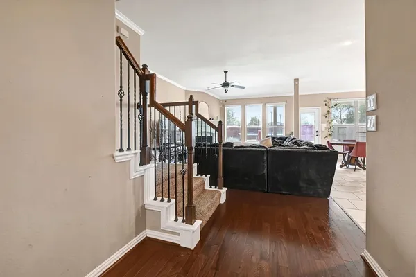 a view of entryway and kitchen with wooden floor