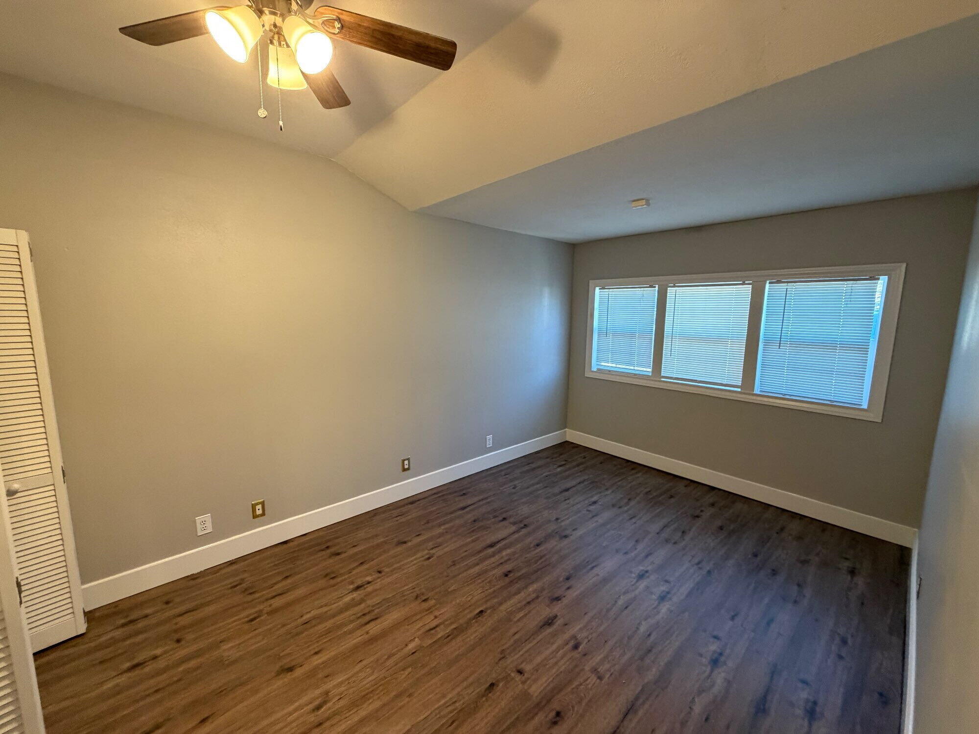 2703 30th Street Lubbock, TX 79410 - Photo 12 of 15 an empty room with wooden floor and windows