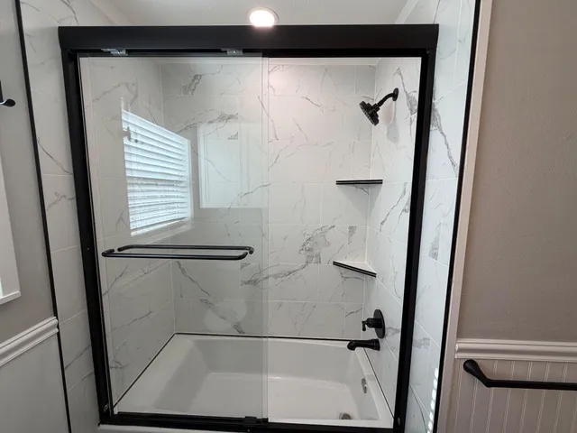 a bathroom with a glass shower door