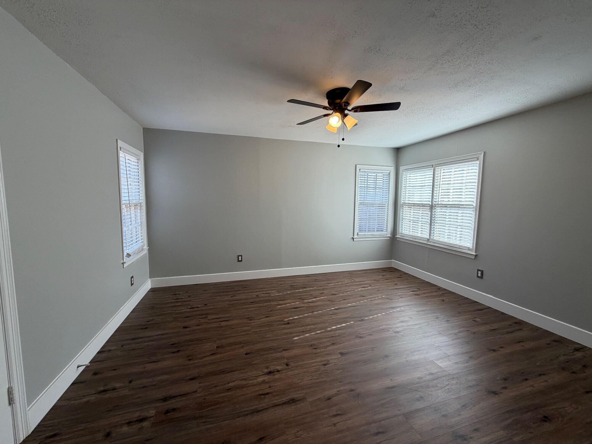 2703 30th Street Lubbock, TX 79410 - Photo 13 of 16 a view of empty room with wooden floor and fan