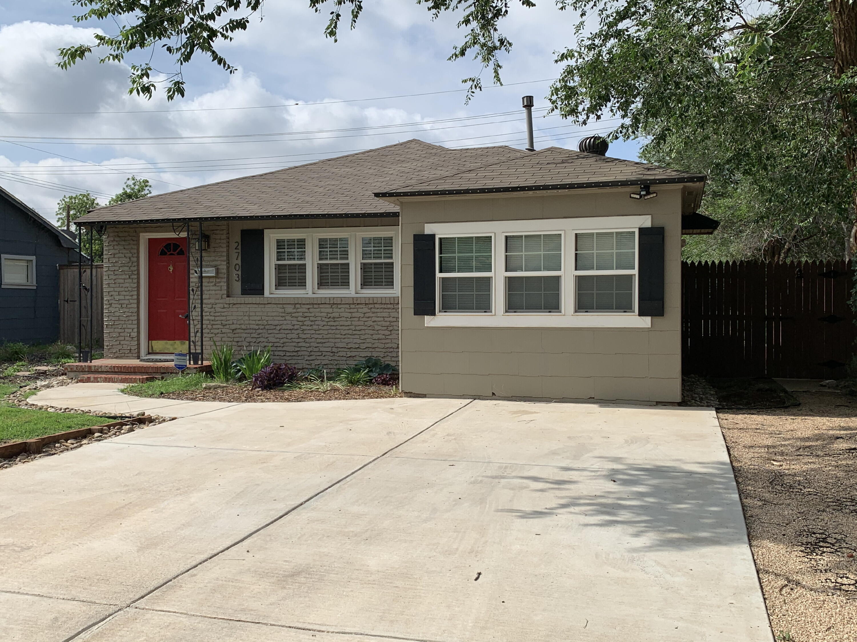 2703 30th Street Lubbock, TX 79410 - Photo 2 of 15 a front view of a house with a yard