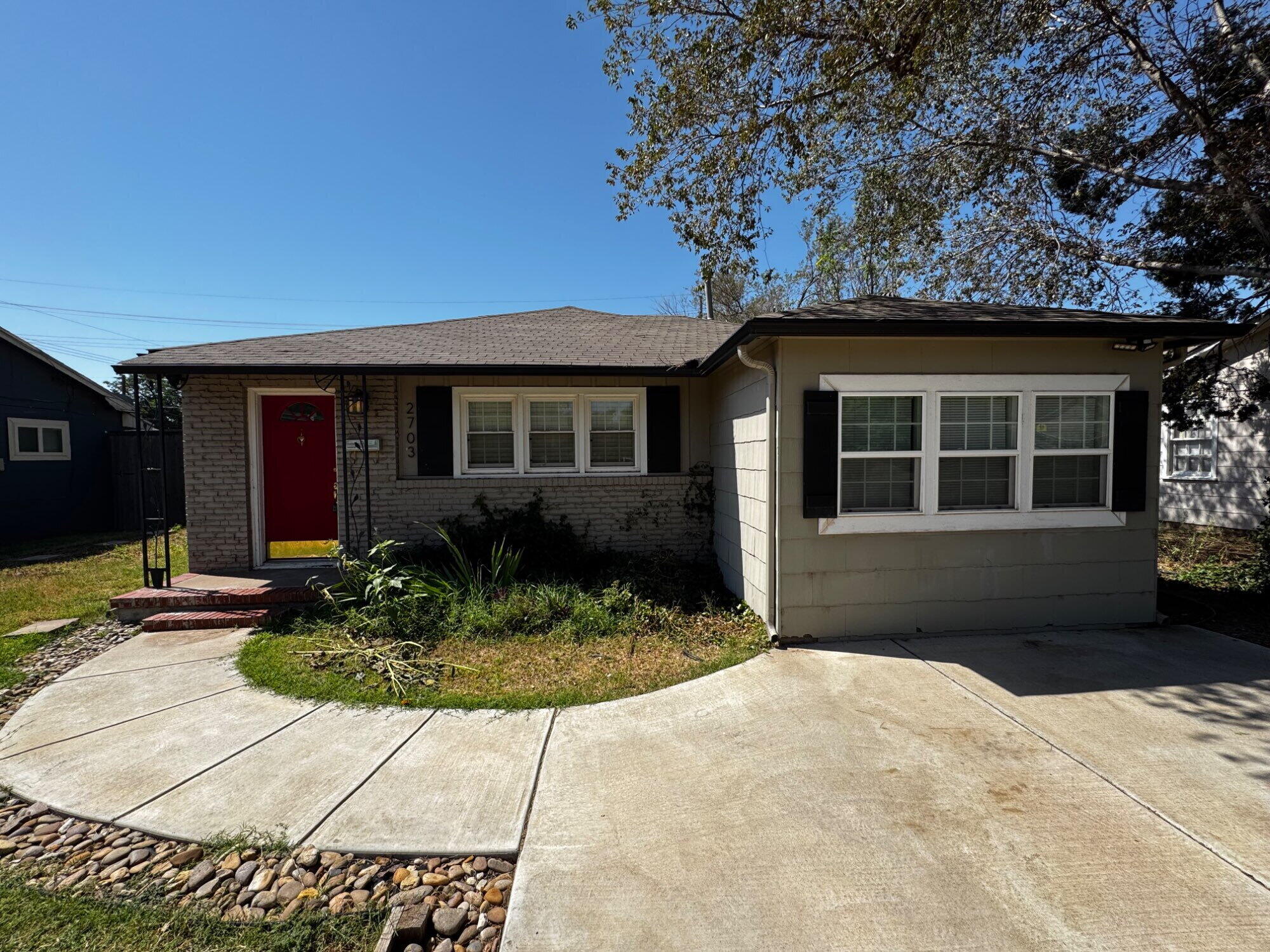 2703 30th Street Lubbock, TX 79410 - Photo 3 of 15 a front view of a house with garden