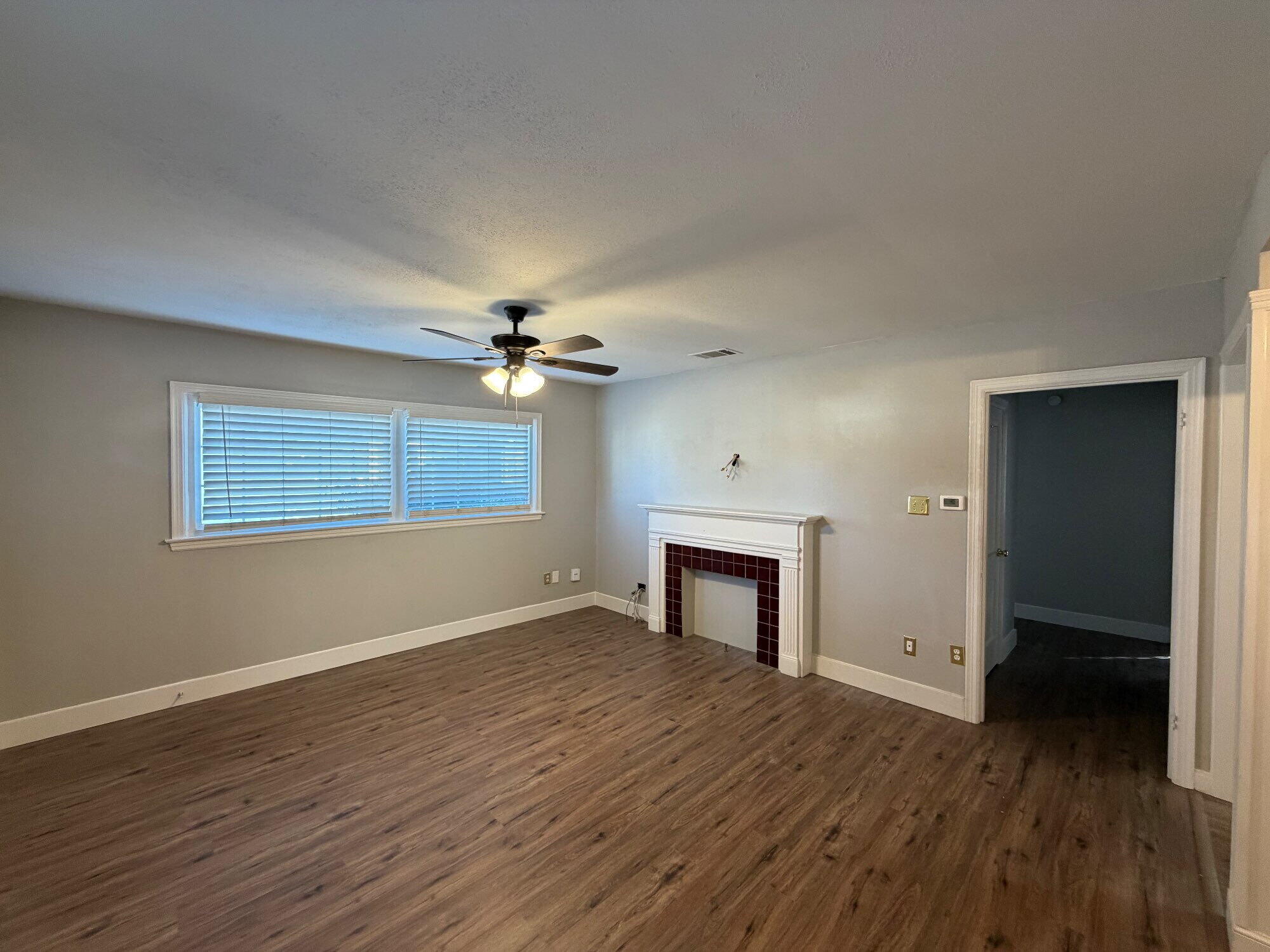 2703 30th Street Lubbock, TX 79410 - Photo 4 of 15 a view of empty room with wooden floor and fan