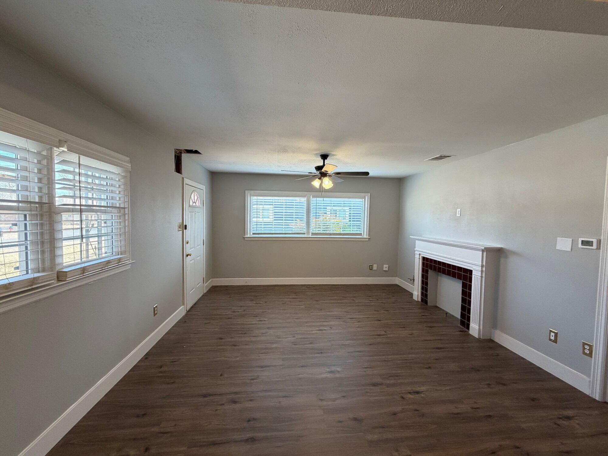 2703 30th Street Lubbock, TX 79410 - Photo 4 of 16 an empty room with windows and fireplace