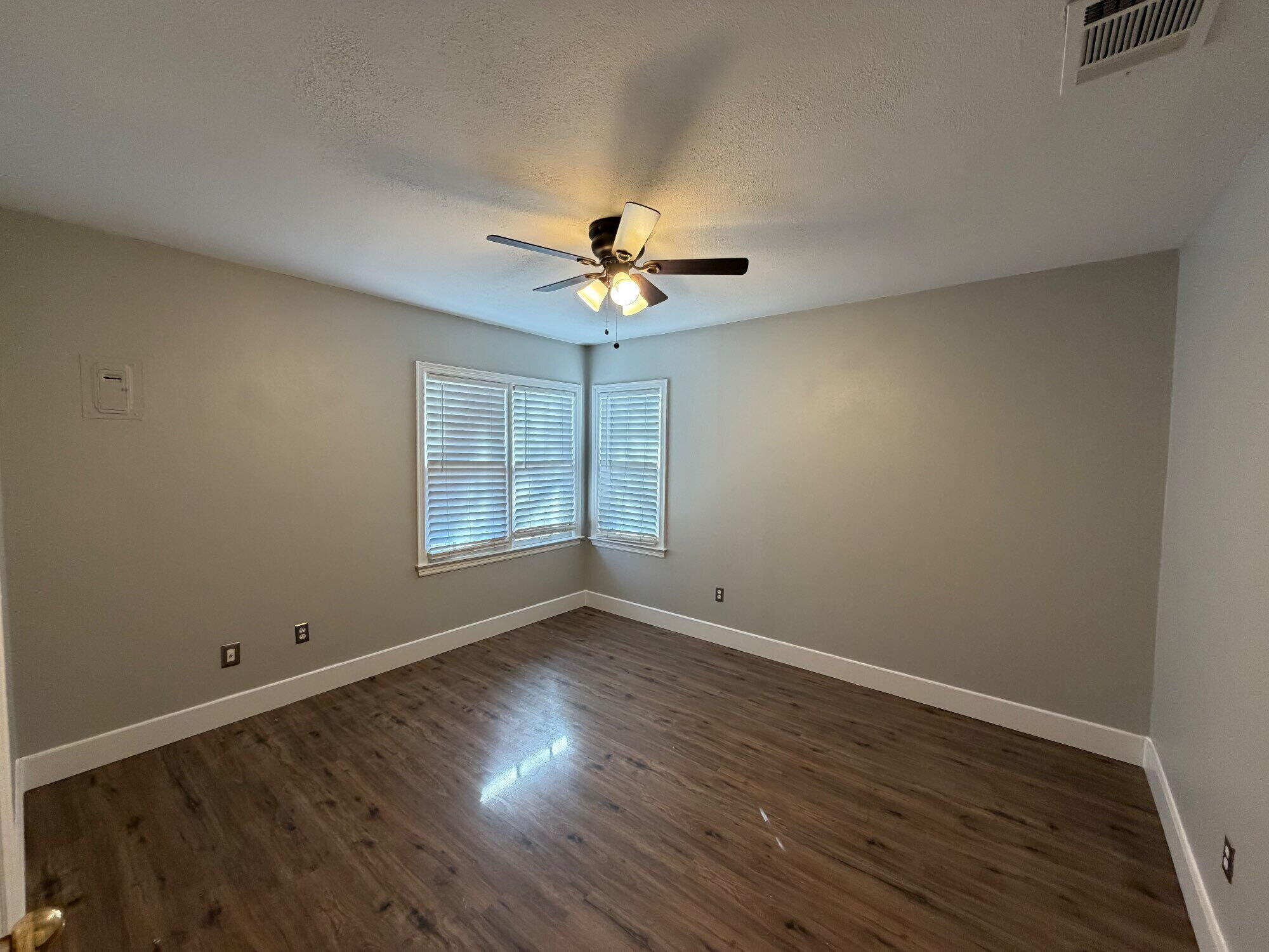 2703 30th Street Lubbock, TX 79410 - Photo 9 of 15 a view of a room with wooden floor and ceiling fan