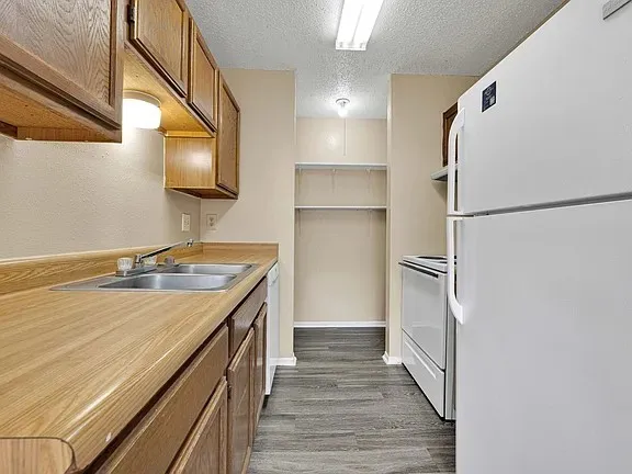 a kitchen with a sink appliances and cabinets