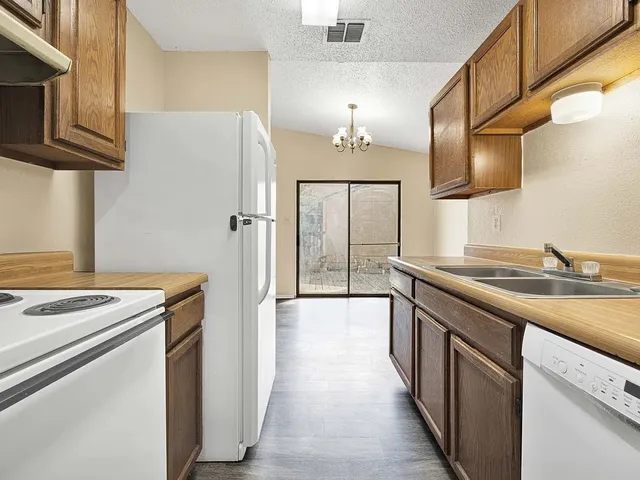 a kitchen with a sink stove and refrigerator