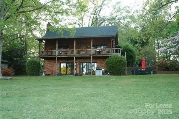 a view of a house with a yard and sitting area