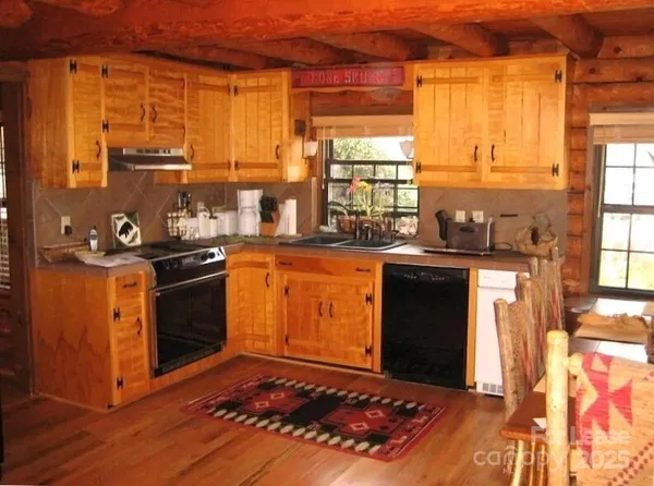 a kitchen with a stove a sink and a microwave