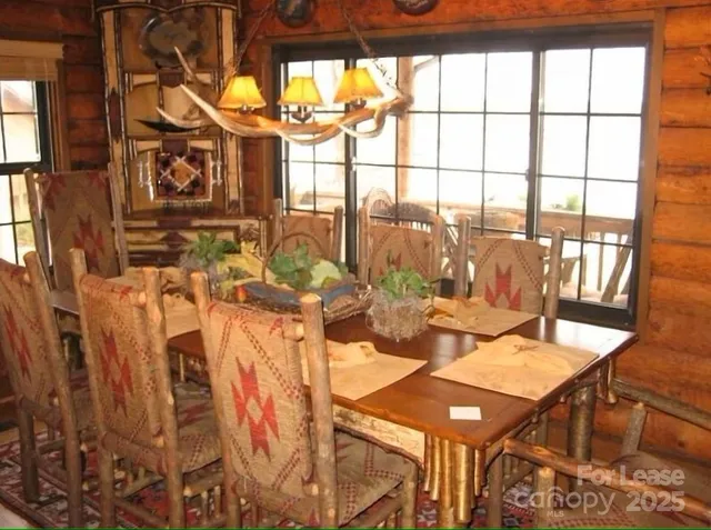 a view of a dining room with furniture and floor to ceiling windows
