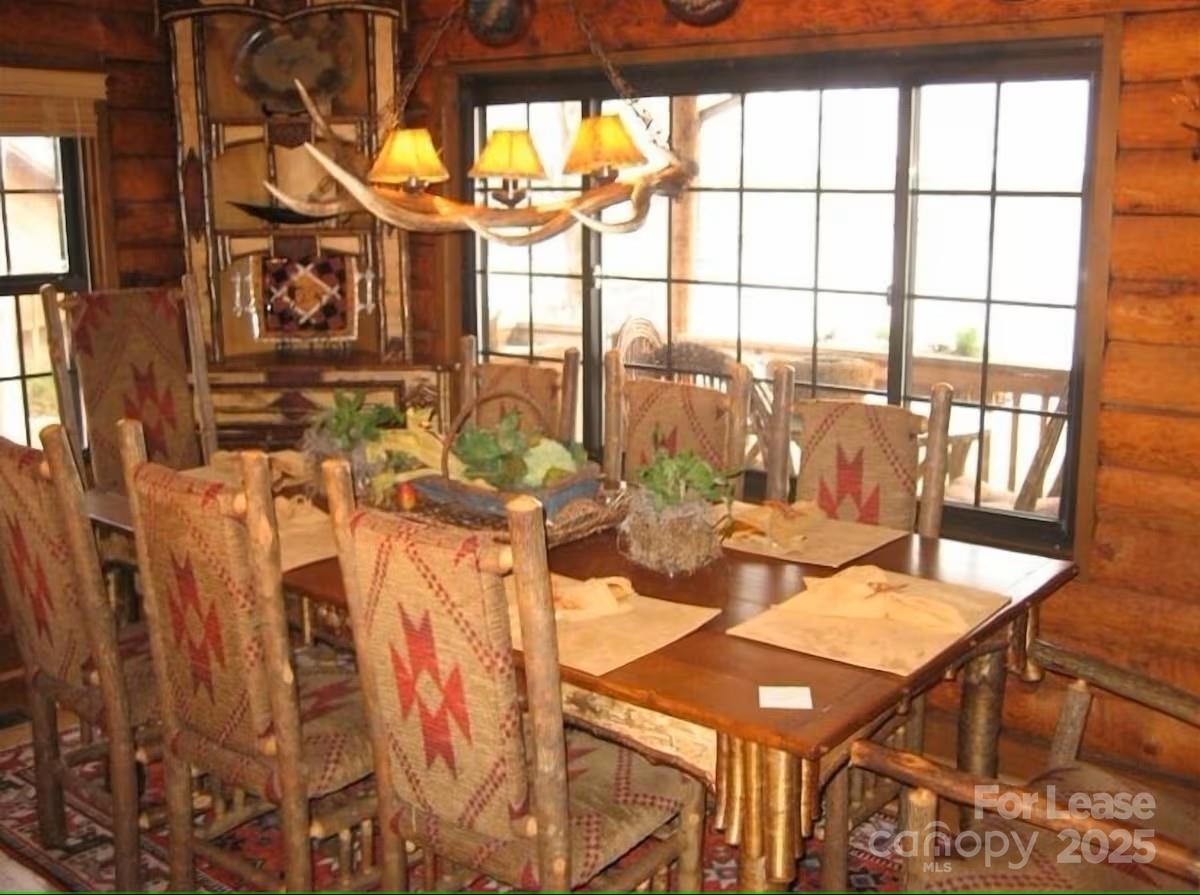 9350 Legrand Drive Terrell, NC 28682 - Photo 5 of 15 a view of a dining room with furniture and floor to ceiling windows