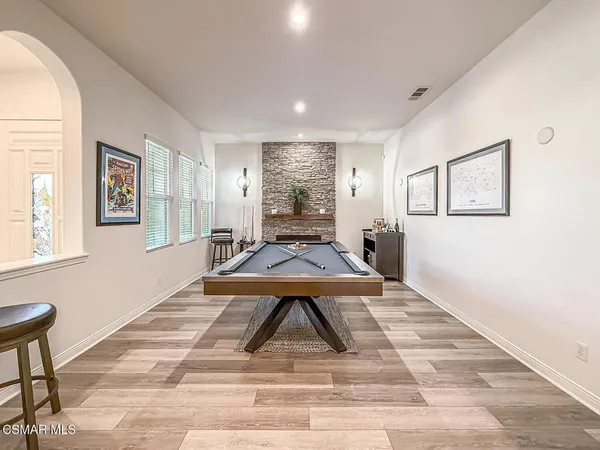 a large kitchen with granite countertop a sink a counter top space stainless steel appliances and cabinets