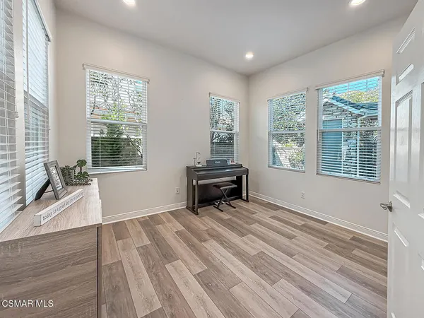 a kitchen with stainless steel appliances granite countertop a stove and a wooden floors