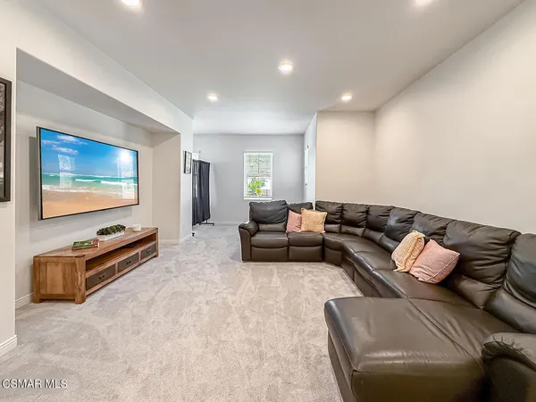 a spacious bedroom with a bed and a large window