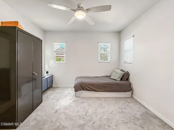 a spacious bathroom with a granite countertop sink and a mirror