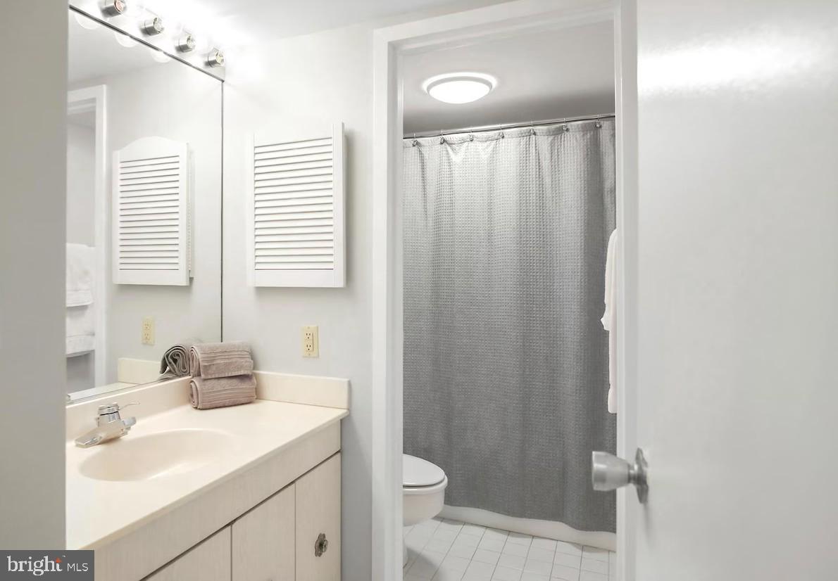 205 East Joppa Road, Unit 608 Towson, MD 21286 - Photo 12 of 26 a bathroom with a sink a toilet and shower