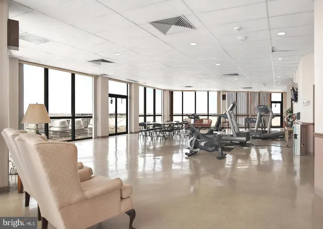 a view of a room with lots of furniture and windows