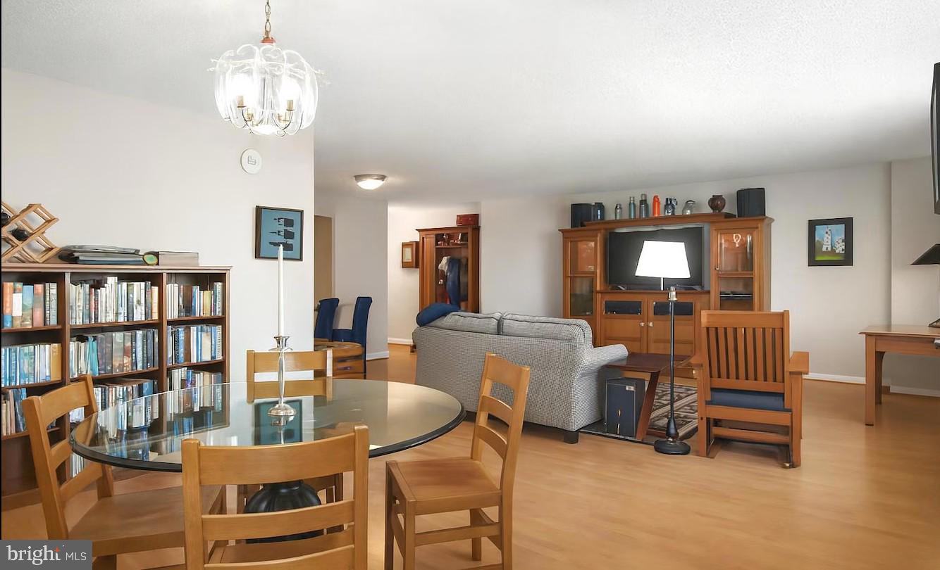 205 East Joppa Road, Unit 608 Towson, MD 21286 - Photo 3 of 26 a living room with furniture a bookshelf and a chandelier