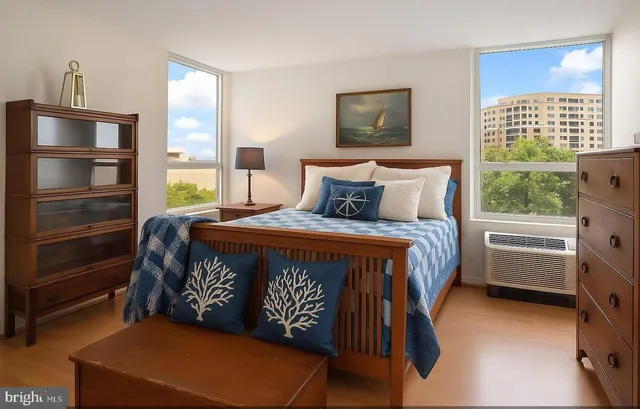 a bedroom with a bed closet and a window