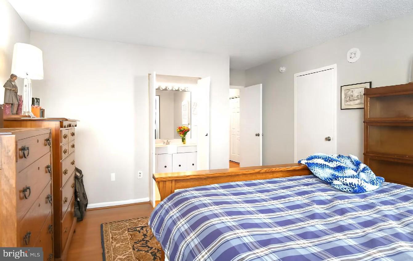 205 East Joppa Road, Unit 608 Towson, MD 21286 - Photo 7 of 26 a bedroom with a bed and wooden floor